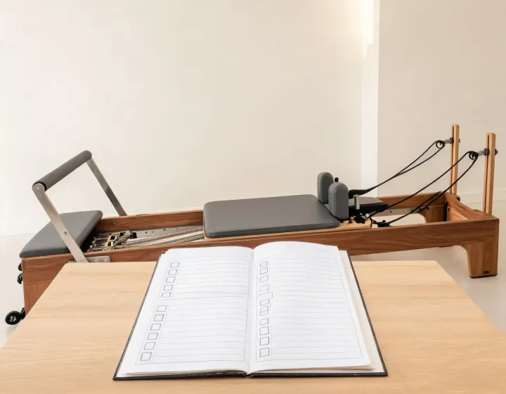 Commercial Pilates studio buyer reviewing a reformer specification sheet
